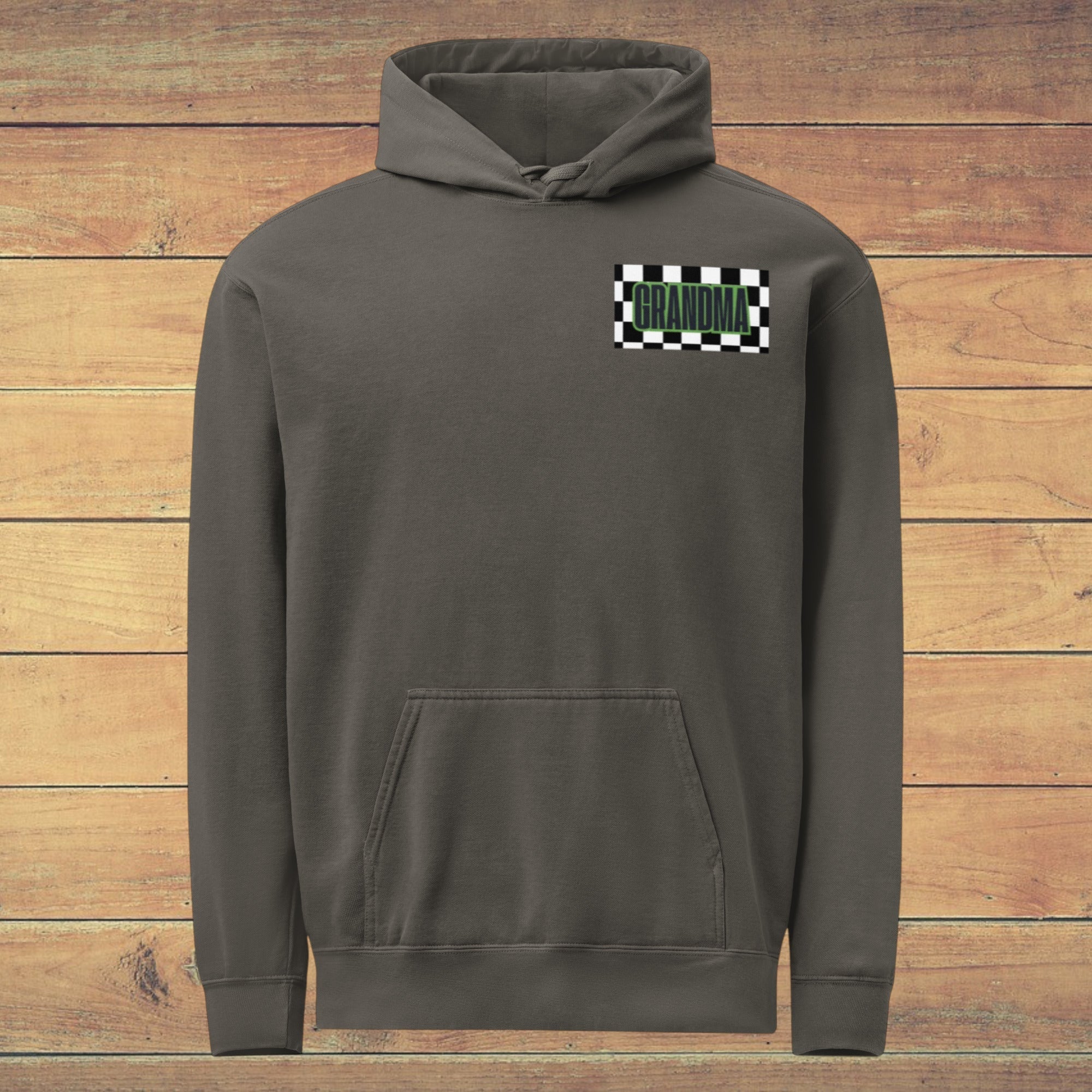 LilLlamaBean charcoal grey graphic hoodie with 'GRANDMA' in green text on a checkered flag patch. Features a relaxed fit, front pouch pocket, and drawstring hood.